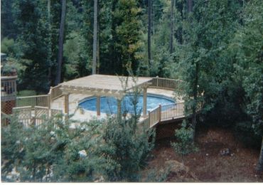 New Pool deck surrounding a 23' above-ground pool with a Greco-Roman inset Hot tub.