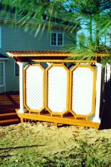 A cabana-style hot tub, pergola with double-sided walls, with router detail work