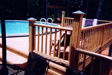This is an above ground, pool, deck platform with pressure-treated lumber and detailed trim on the r