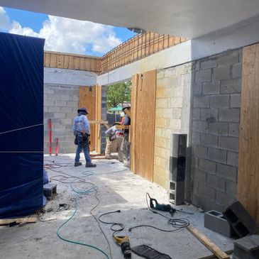 Residential construction with worker in background