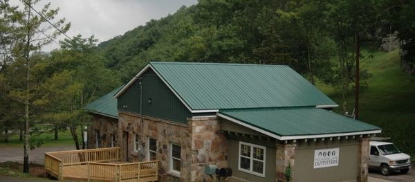 Renovated stone building with green roof and deck.