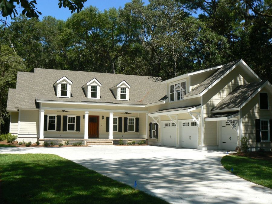 Custom home with three-car garage and front porch.