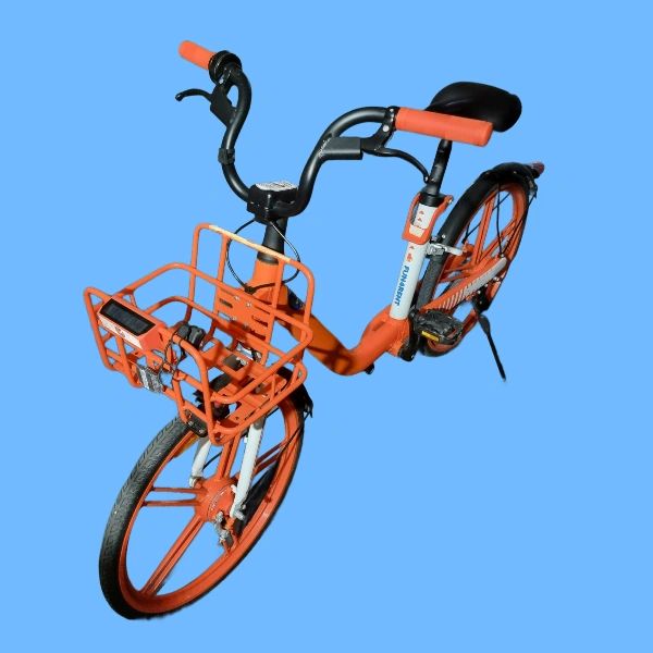 Orange and black rental bicycle with a front basket.