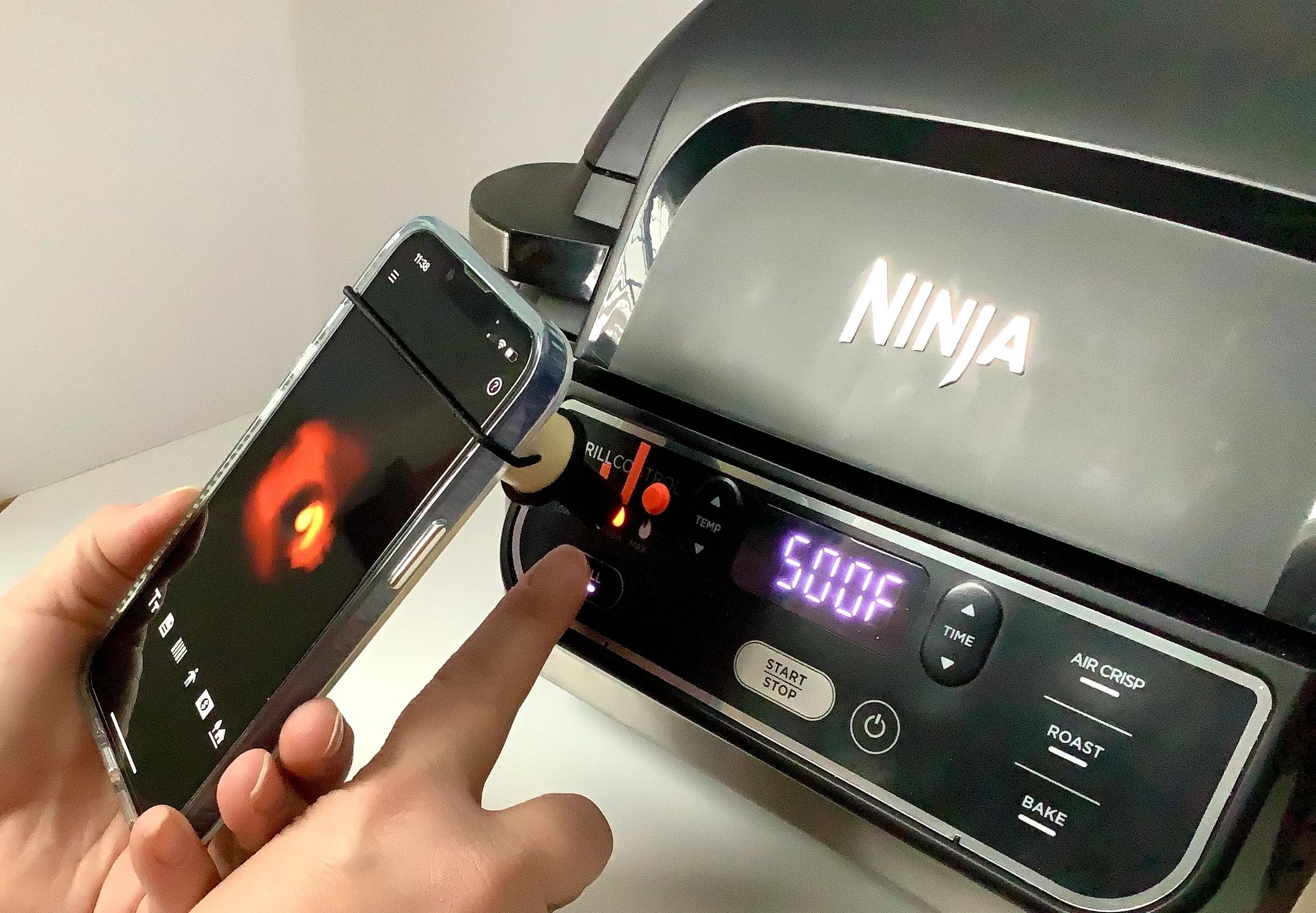  A smart phone with the Precise Point adapter against a light indicator on the Ninja Foodi Grill.