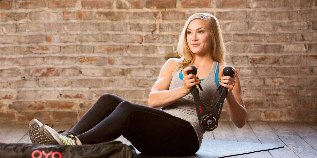 Lady using the OYO Fitness Personal Gym for core and arm muscle strengthening