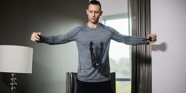 Man using the OYO Fitness Personal Gym for chest muscle strengthening at home