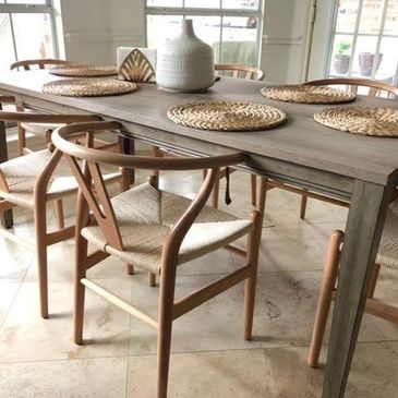 Wishbone style chairs with a woven seat design