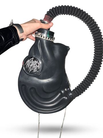 Black futuristic gas mask with hose held by hand.
