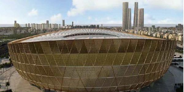 Modern stadium with unique hexagonal exterior design in a cityscape.