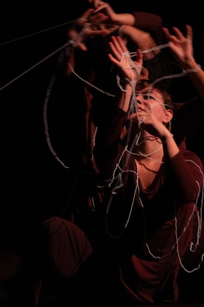Person entangled in strings with motion blur effect.