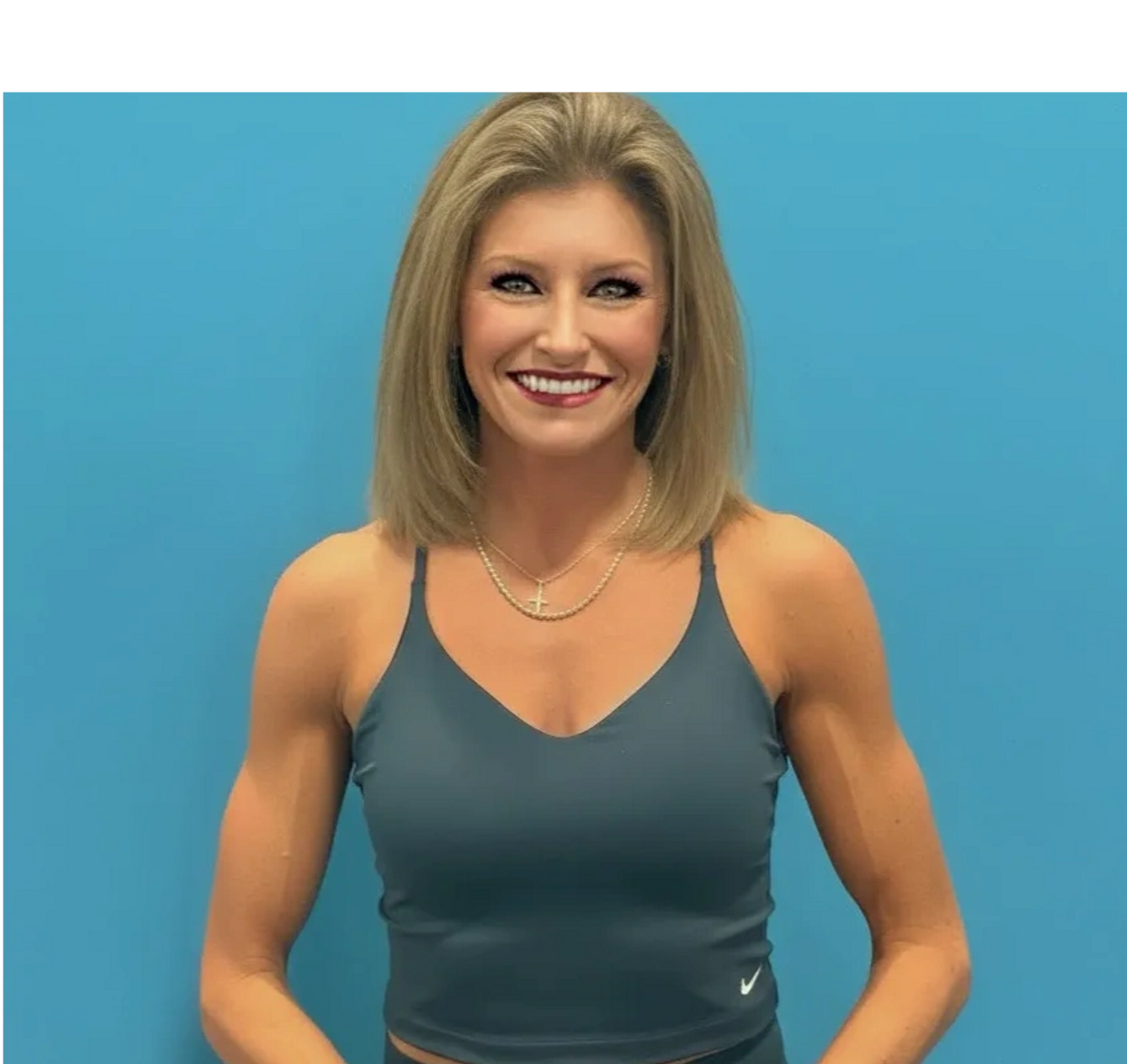 Smiling blond personal trainer's headshot