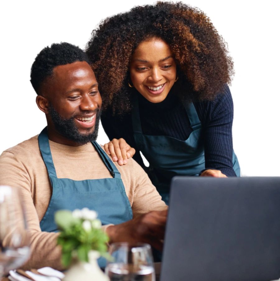 Business owners smiling looking at a computer