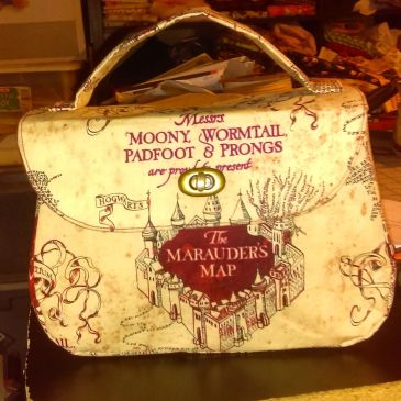 A Marauders Map-themed handbag with a Hogwarts castle design.