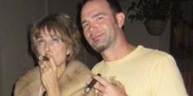 Author joking cigar in mother's mink with Greg Boswell