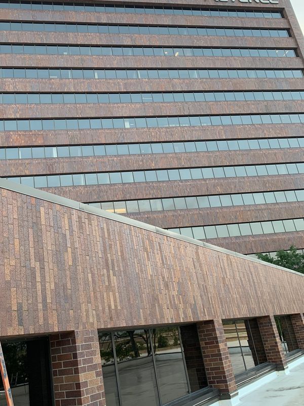 Multi-story Keyence office building with brick facade and glass windows.