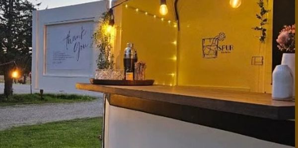 "Rustic mobile bar trailer rental setup at outdoor wedding in Ontario"