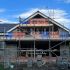 House under construction with scaffolding and building materials