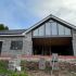House under construction with exposed brick and unfinished exterior