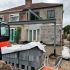 House extension under construction with steel beams and concrete foundation