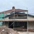 House extension under construction with scaffolding and exposed framework