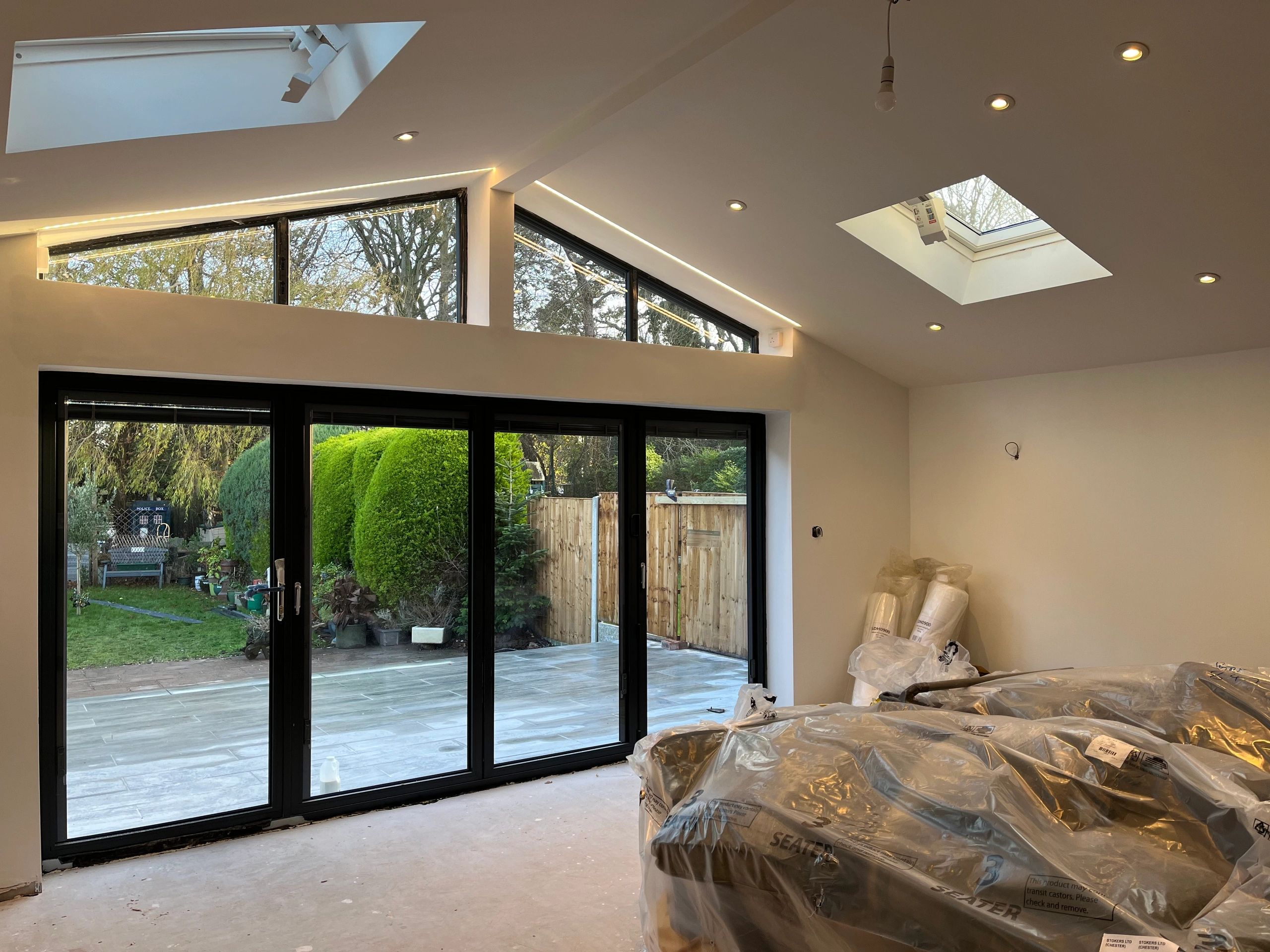 Room under renovation with large glass doors and skylights