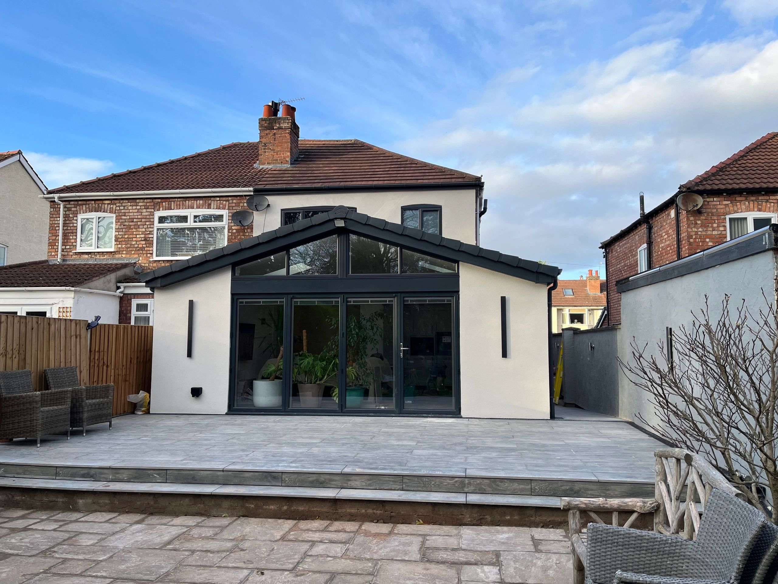 House extension with large glass doors and patio