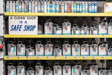 Shelves of hand sanitizers with a cleanliness sign.