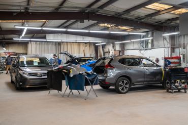 Auto repair shop with cars being serviced.