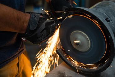 Person grinding metal with sparks flying.