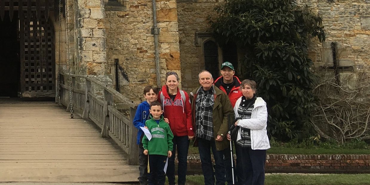 Angela Leavens and family outside a British castle.  Her parents are world travellers who are blind.