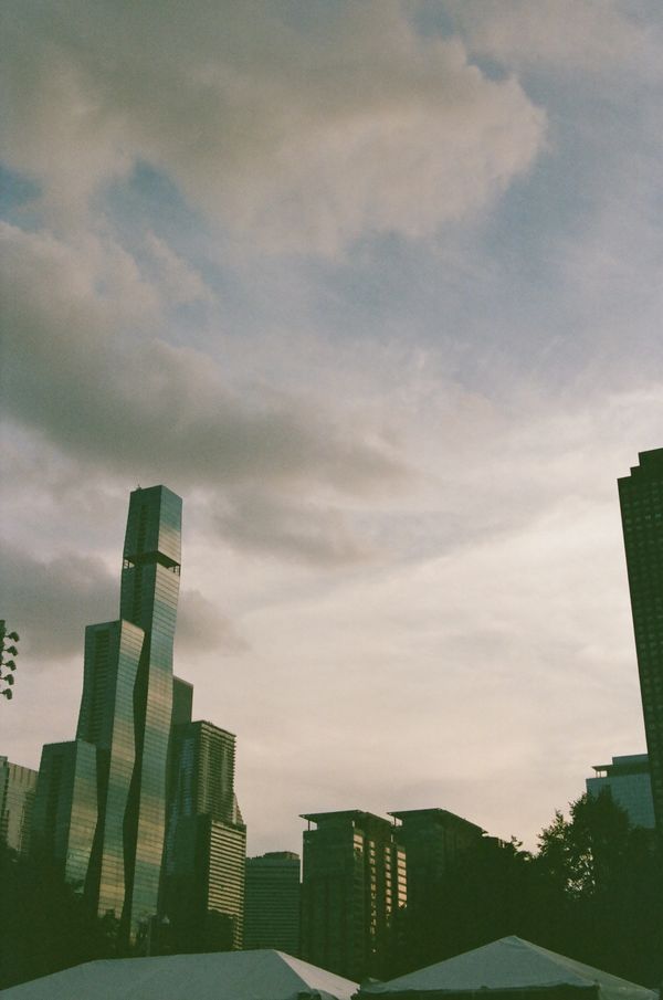City skyline with modern buildings under a cloudy sky.