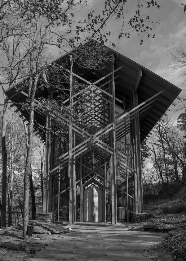 Modern glass and wood chapel in a forest.