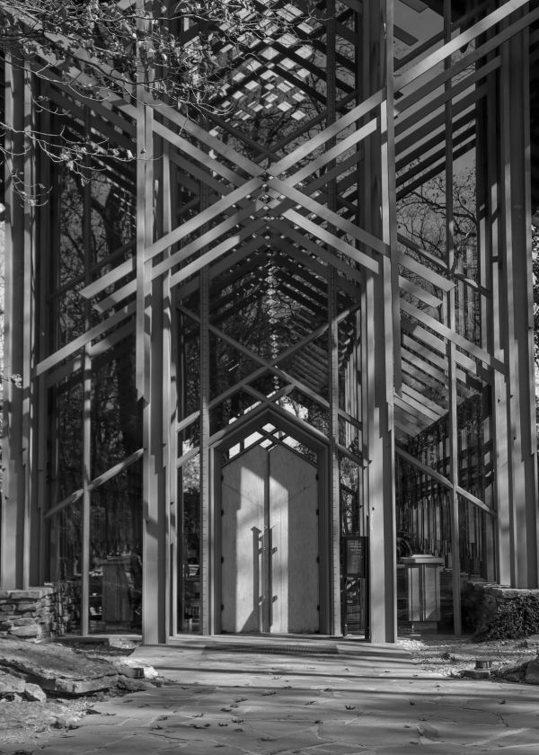 Modern glass and metal structure with geometric patterns.