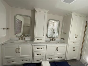 Bathroom remodel with plentiful storage, drawer below sinks, new quartz countertops, & tiled shower