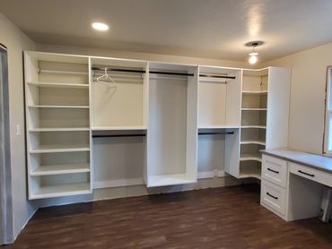 Closet system wall with makeup vanity in front of window