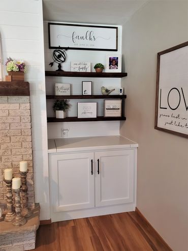 Lift-up painted wood top on built-in base cabinet with matte black hardware