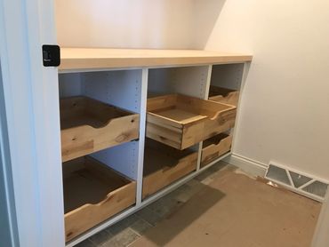 White melamine pantry cabinetry with rustic white birch dovetailed roll-outs