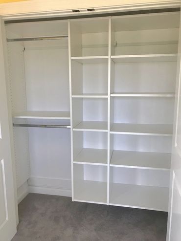 Hanging and folding clothing storage in white melamine closet system 