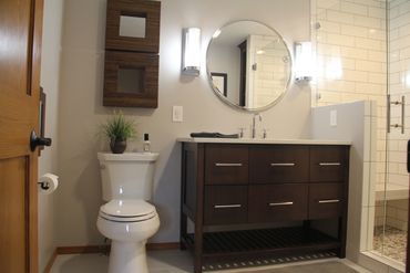 Custom vanity with slatted open shelf below slab front drawers