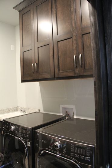 Uppers above washer/dryer with custom paneled shaker style doors