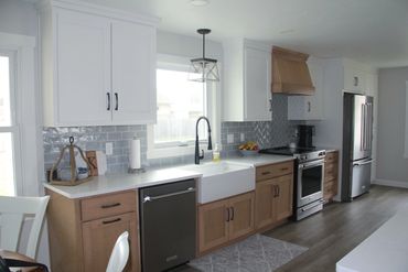 White painted uppers with stained maple base cabinets and custom range hood