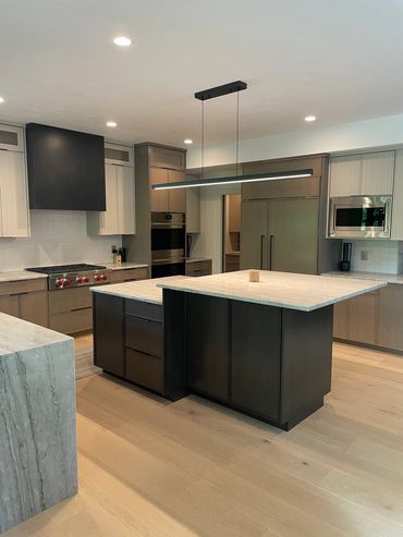 Custom made door panels on tri-tone frameless kitchen with oak and painted accents