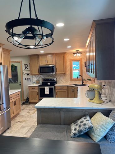 Kitchen remodel with matching cabinets and trim work with eat-in dining room bench