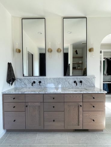 Custom stain on plain sawn white oak vanity with marble countertop including shelf and backsplash