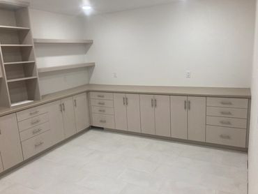 Laminated frameless craft room cabinetry with floating shelf storage 