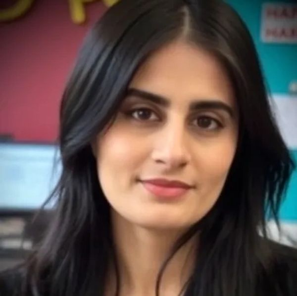 Portrait of a woman with long black hair and a subtle smile.