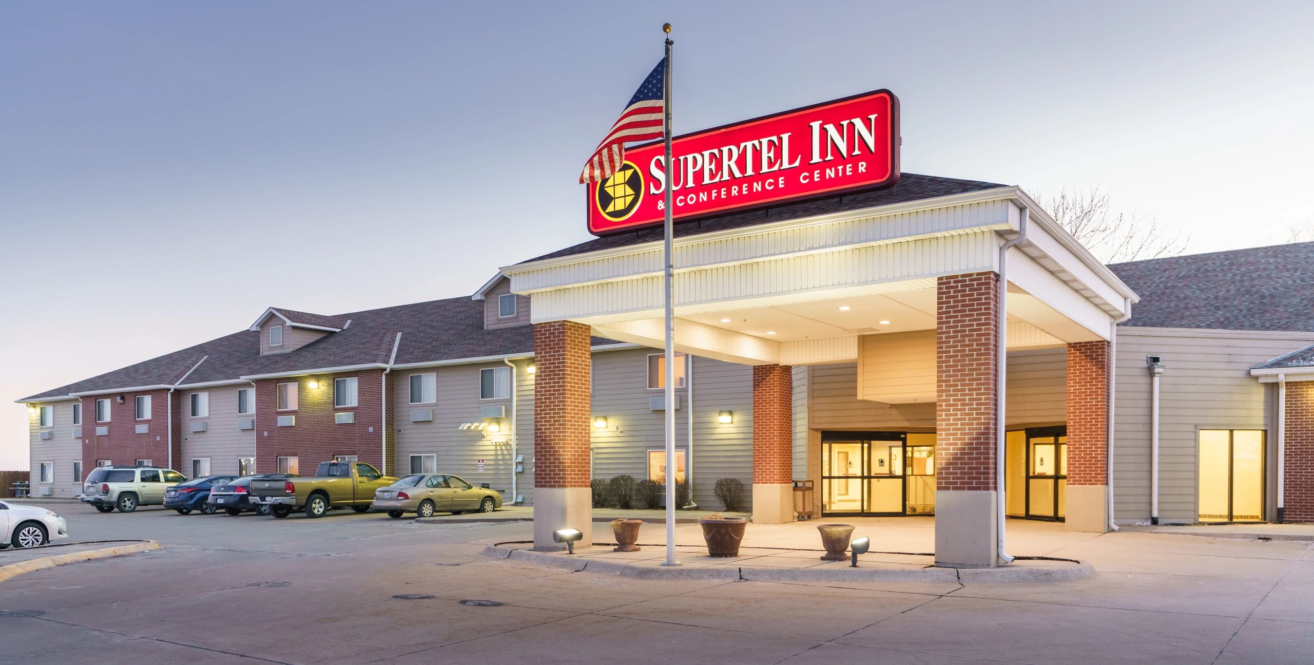 Bright, spacious hotel room with warm tones and modern furnishings.