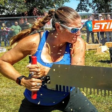 World Champion lumberjill using crosscut saw in professional timbersports competition