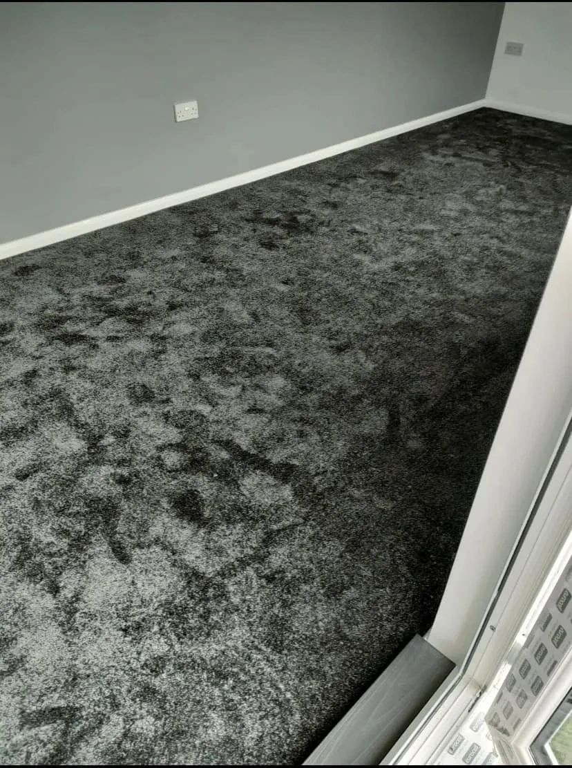 a black color carpet on the floor in a room 