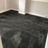 a black color carpet on the room floor 